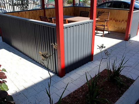 corrugated metal and wood fence