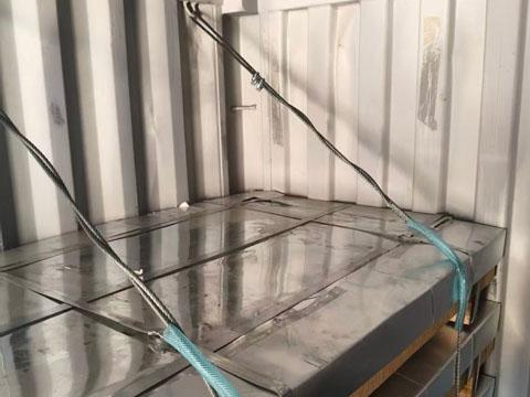 Details of sheet metal being loaded into containers